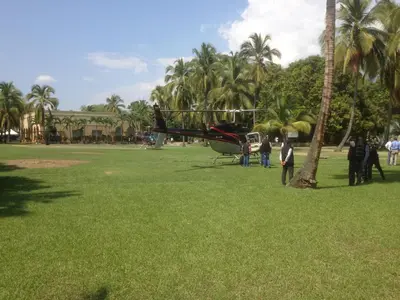 a small plane parked in a field with people standing around at Hotel y Spa Santa Fe Colonial in Santa Fe de Antioquia