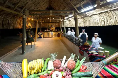 a group of people standing in a market with fruits and vegetables at Hotel y Spa Santa Fe Colonial in Santa Fe de Antioquia
