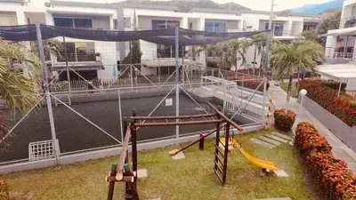 a playground with a slide and a swing at Ciudadela Santa fe Apartasol 4 A 2 in Santa Fe de Antioquia