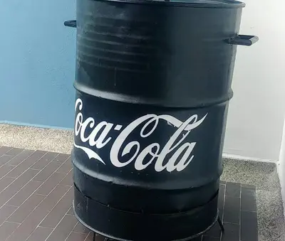 a large black barrel with cocacola written on it at Ciudadela Santa fe Apartasol 4 A 2 in Santa Fe de Antioquia