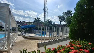 a fence in front of a swimming pool with a pool at Ciudadela Santa fe Apartasol 4 A 2 in Santa Fe de Antioquia