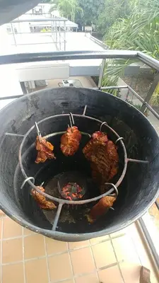 a grill with some food cooking on it at Ciudadela Santa fe Apartasol 4 A 2 in Santa Fe de Antioquia