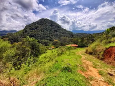 a dirt road in front of a mountain at La Perla Negra - Black Pearl Eco Hostel in San Rafael