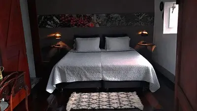 a bedroom with a bed with a white comforter at La Estancia Hotel Boutique in Salamina