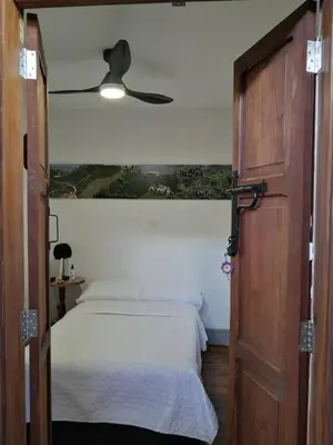 a bedroom with a bed and a ceiling fan at La Estancia Hotel Boutique in Salamina