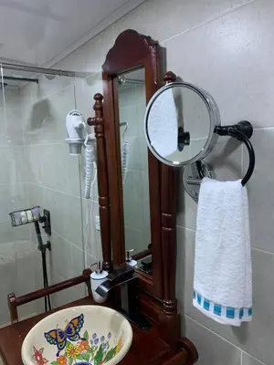 a bathroom with a mirror and a sink at La Estancia Hotel Boutique in Salamina