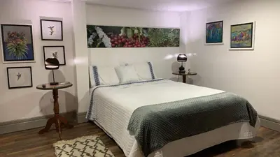 a bedroom with a bed and some pictures on the wall at La Estancia Hotel Boutique in Salamina