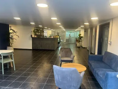 a lobby with a couch and chairs and a table at Modern Apartment Ultra Fast Internet in El Poblado in Medellín