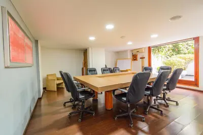 a conference room with a wooden table and chairs at Modern Apartment Ultra Fast Internet in El Poblado in Medellín