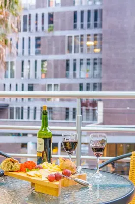 a table with a bottle of wine and two glasses at Modern Apartment Ultra Fast Internet in El Poblado in Medellín
