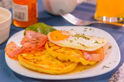 a plate of breakfast food with an egg on top at Modern Apartment Ultra Fast Internet in El Poblado in Medellín