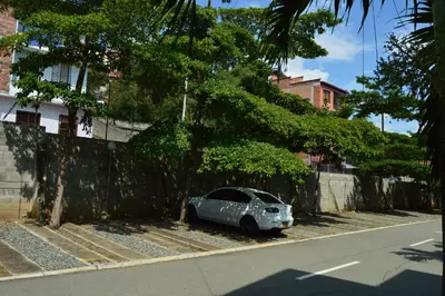 a car parked on the side of a street at Apartasol Santa Fe de Antioquia in Santa Fe de Antioquia