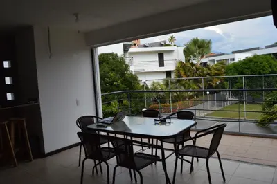 a table and chairs on a balcony with a view at Apartasol Santa Fe de Antioquia in Santa Fe de Antioquia