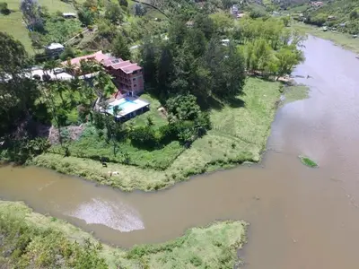 an aerial view of a house next to a river at HOTEL EL POTRILLO in El Peñol