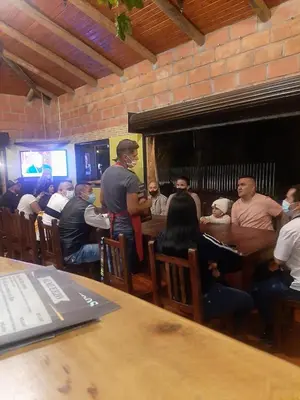 a group of people sitting at a table in a restaurant at HOTEL EL POTRILLO in El Peñol