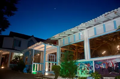 a building with a lit up facade at night at Eco Hotel Terrabella in Santa Elena