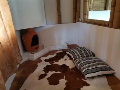 a room with a couch on the floor with a window at Eco Hotel Terrabella in Santa Elena