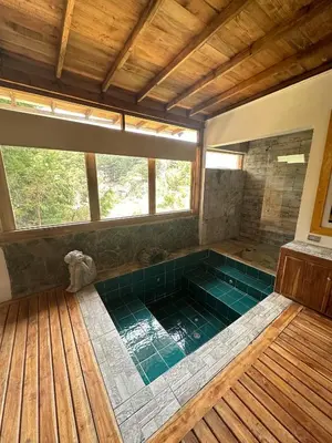 a large bathroom with a large tub with a window at Eco Hotel Terrabella in Santa Elena