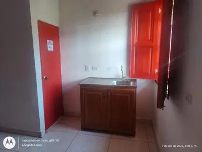 a small kitchen with a sink and a red cabinet at Casa Hotel Villa Marta in Jericó