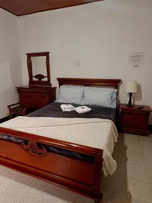a bedroom with a bed with two towels on it at Hotel Tahami in Sonsón
