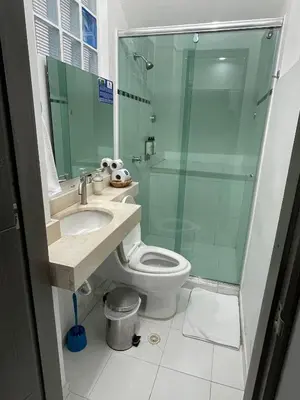 a bathroom with a toilet and a glass shower at Hotel Boutique San Rafael in Mariquita