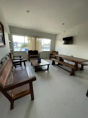 a living room with wooden benches and tables at Hotel Boutique San Rafael in Mariquita