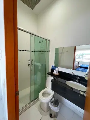 a bathroom with a shower and a toilet and a sink at Hotel Boutique San Rafael in Mariquita