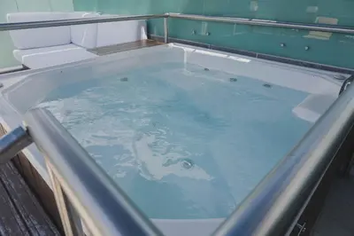 a bath tub filled with water in a bathroom at Hotel Boutique San Rafael in Mariquita