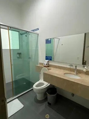 a bathroom with a toilet and a shower and a sink at Hotel Boutique San Rafael in Mariquita