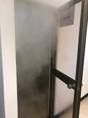 a metal door with smoke coming out of it at Hostal El Eden Manizales in Manizales