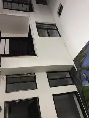 a building with windows on the side of it at Hostal El Eden Manizales in Manizales