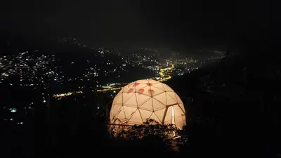 a domed object is lit up at night at Glamping la Fortuna in Girardota