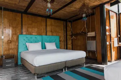 a bedroom with a bed with a blue headboard at Hotel Resort Del Cafe in Manizales