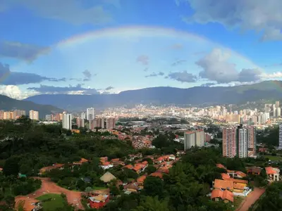 a view of a city with a rainbow in the sky at Paraíso en la ciudad in Medellín