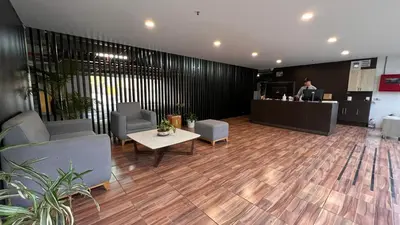 a lobby with chairs and a table and a counter at Paraíso en la ciudad in Medellín