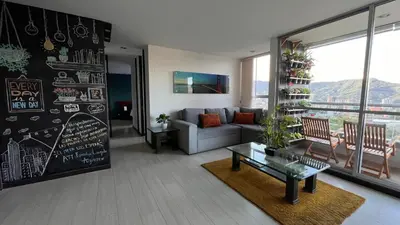 a living room with a couch and a table at Paraíso en la ciudad in Medellín