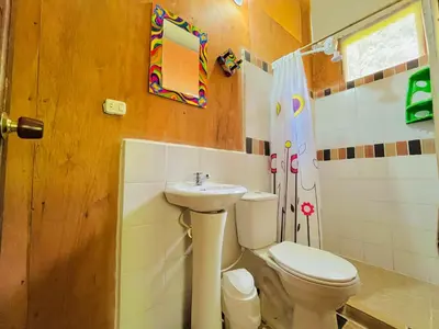 a bathroom with a toilet and a sink at Cabañas con cascada privada & vistas a la montaña Naturaleza total in Jardin