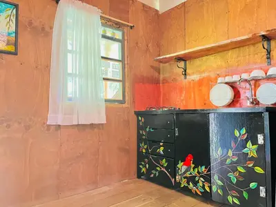 a kitchen with a cabinet and a window at Cabañas con cascada privada & vistas a la montaña Naturaleza total in Jardin