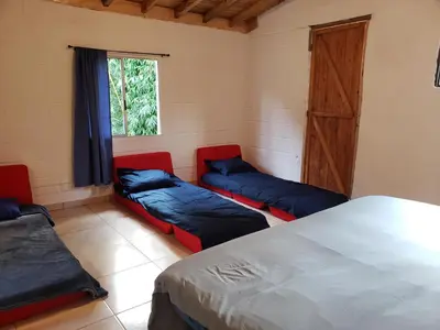 a room with two beds and a window at Ensenillo Hotel Boutique in Rionegro