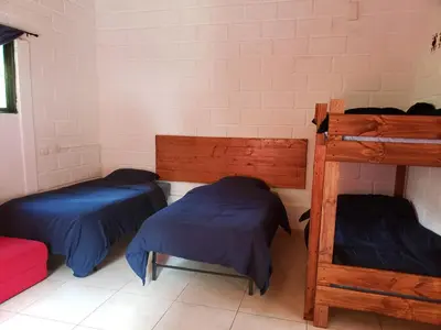 a room with two beds and two bunk beds at Ensenillo Hotel Boutique in Rionegro