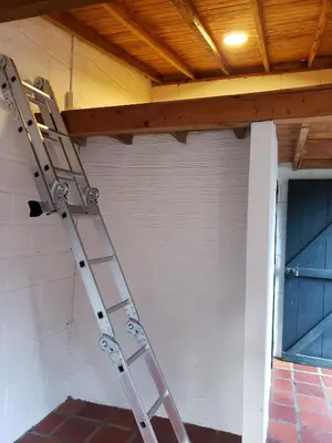 a ladder leaning against a wall next to a door at Ensenillo Hotel Boutique in Rionegro