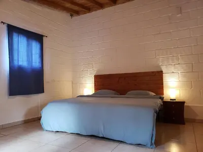 a bedroom with a large white bed with a window at Ensenillo Hotel Boutique in Rionegro