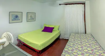 a small room with a bed and a window at ALDEA VACACIONAL LA FLORIDA Apto 103 Bloque 1 in Santa Fe de Antioquia