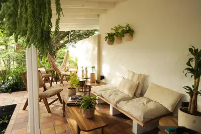 a living room with a couch and a table with plants at Hotel Quinta Ladera in Medellín
