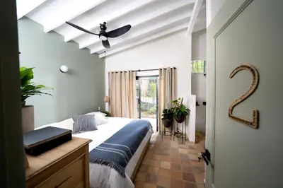 a bedroom with a bed and a ceiling fan at Hotel Quinta Ladera in Medellín