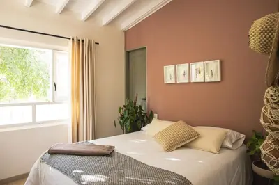 a bedroom with a bed and a window at Hotel Quinta Ladera in Medellín