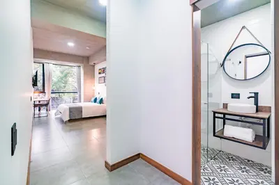 a bathroom with a sink and a mirror in a room at Loft 32 Medellín Living in Medellín