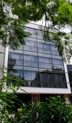a tall glass building with a lot of windows at Loft 32 Medellín Living in Medellín