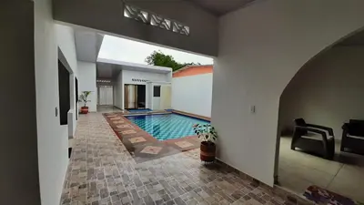 a swimming pool in the middle of a house at Casa piscina in Mariquita