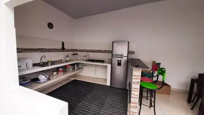 a kitchen with a stainless steel refrigerator in a room at Casa piscina in Mariquita